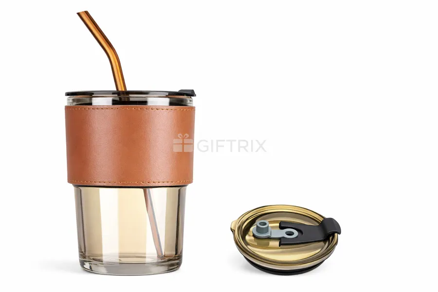 Glass cup with tan leather sleeve, metal straw, and flip lid